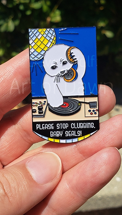 Photo of hand holding Please Stop Clubbing, Baby Seals pin